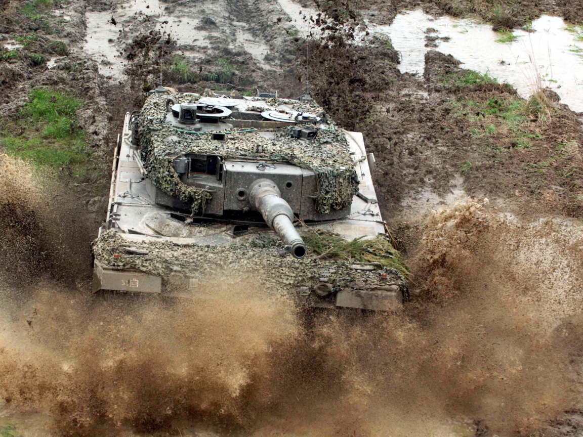 Танк в маскировке едет по грязи
