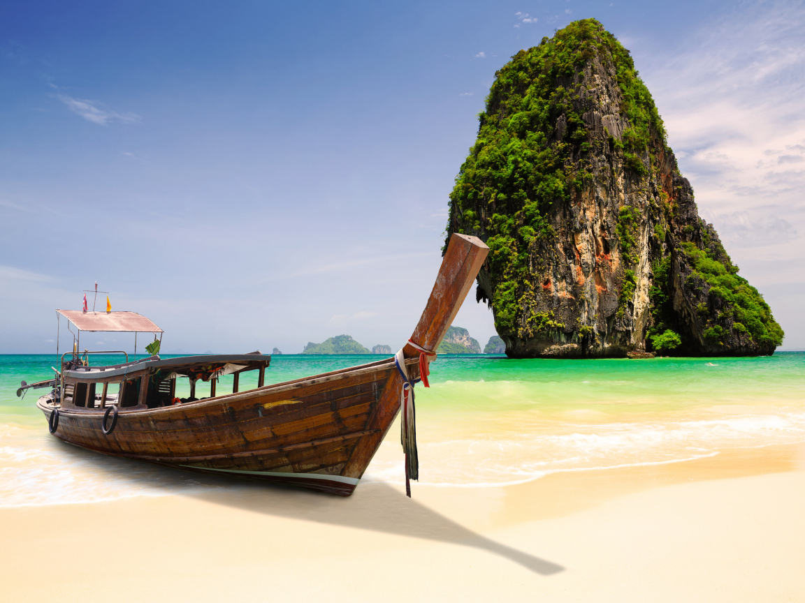 Boat on the background of rocks at the resort in Krabi, Thailand