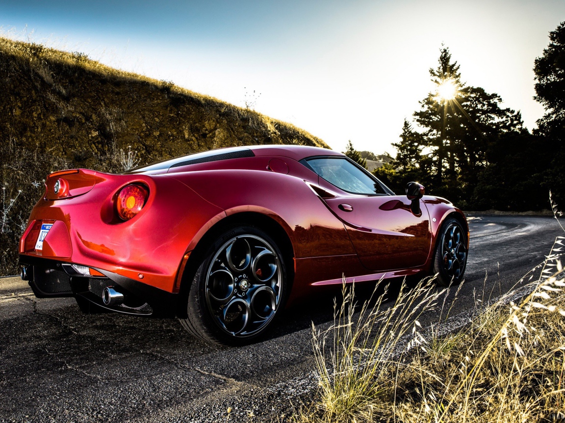 Красная Alfa Romeo 4C на повороте дороги