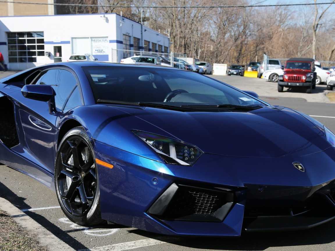 Темно синий автомобиль Lamborghini Aventador припаркован на улице