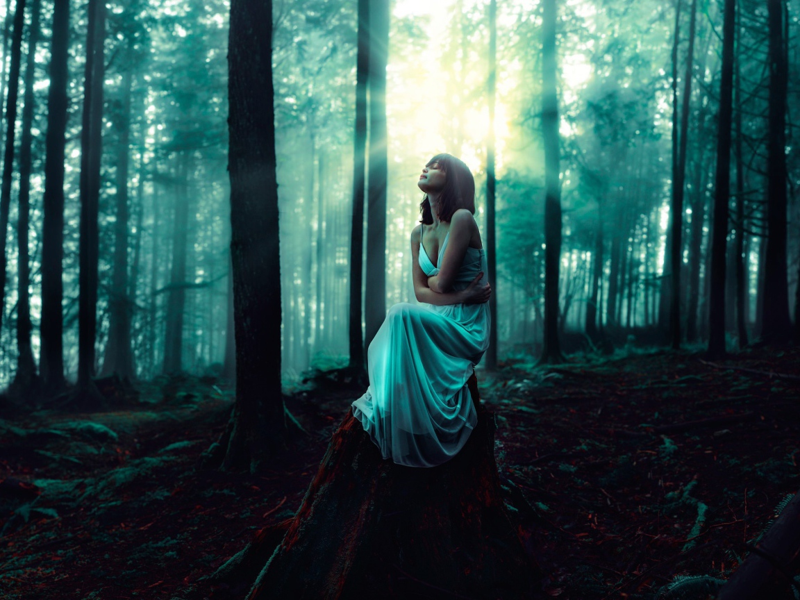 Девушка сидит на старом пеньке