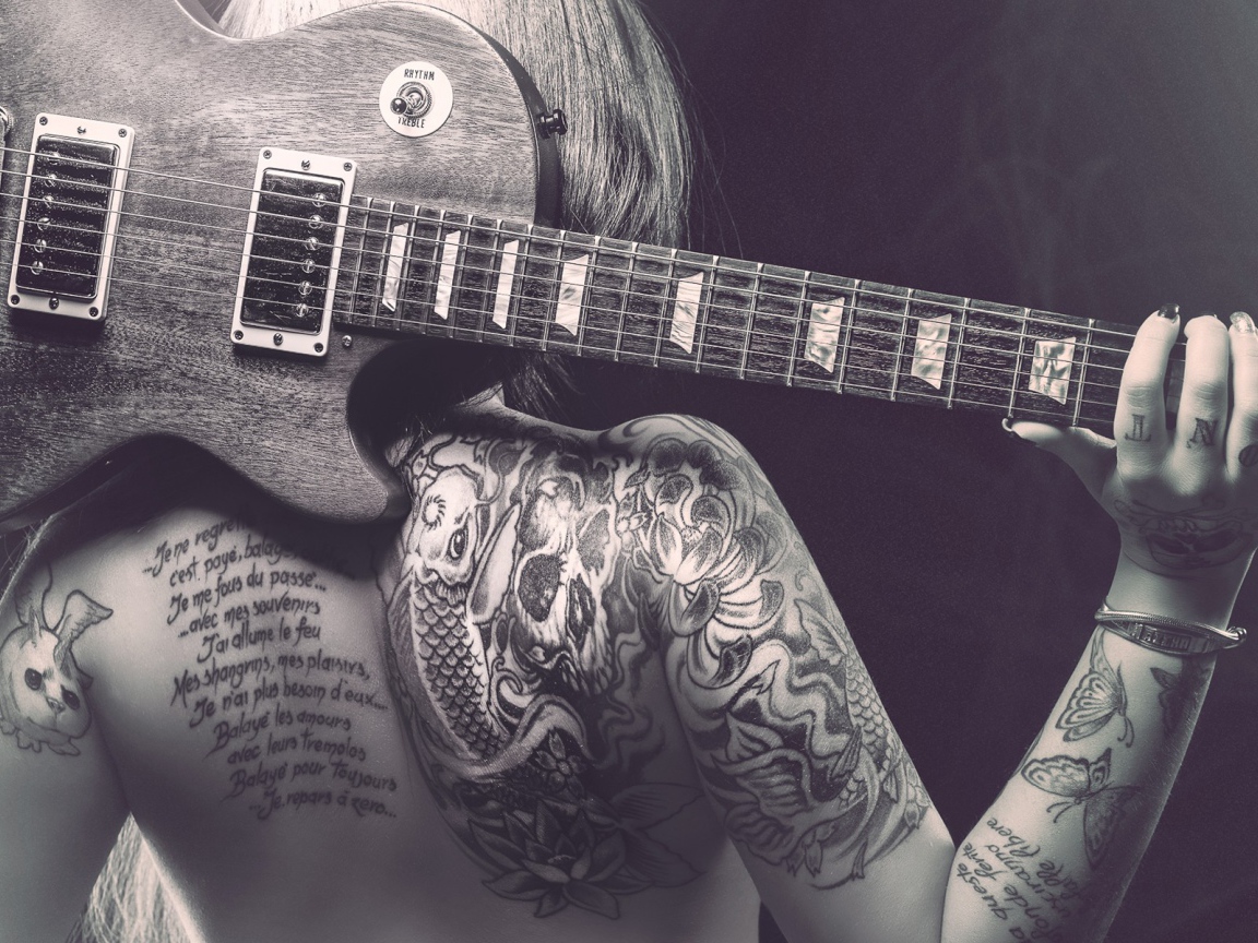 Guitar on his back tattooed girl