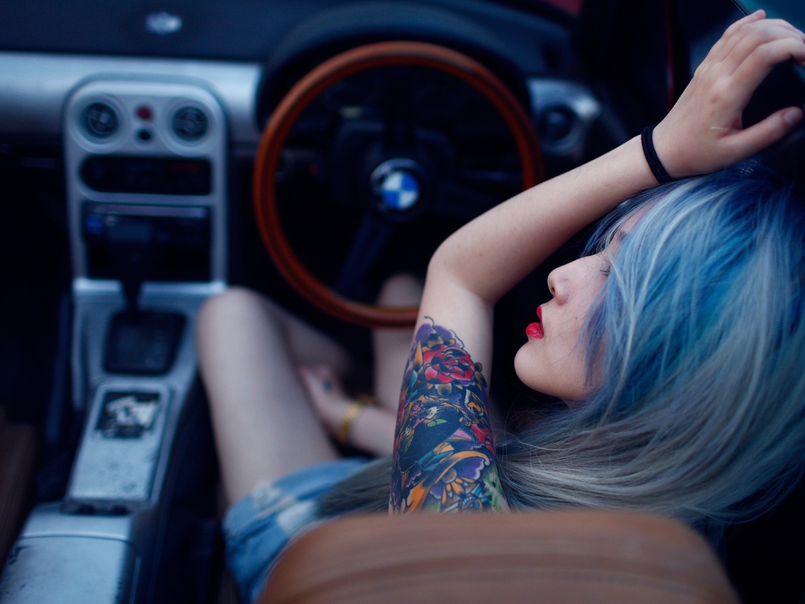 Japanese girl with tattoos driving a car