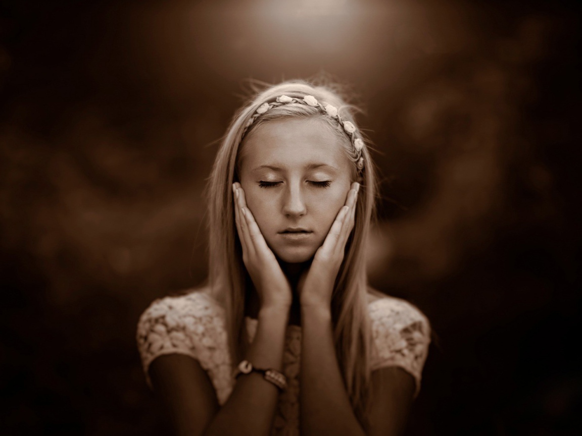 Девушка прикоснулась руками к лицу