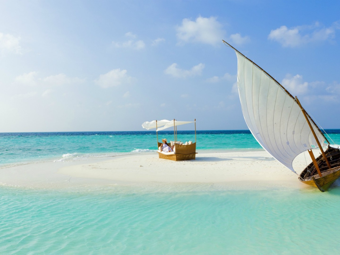 Парусная лодка у песчаного островка