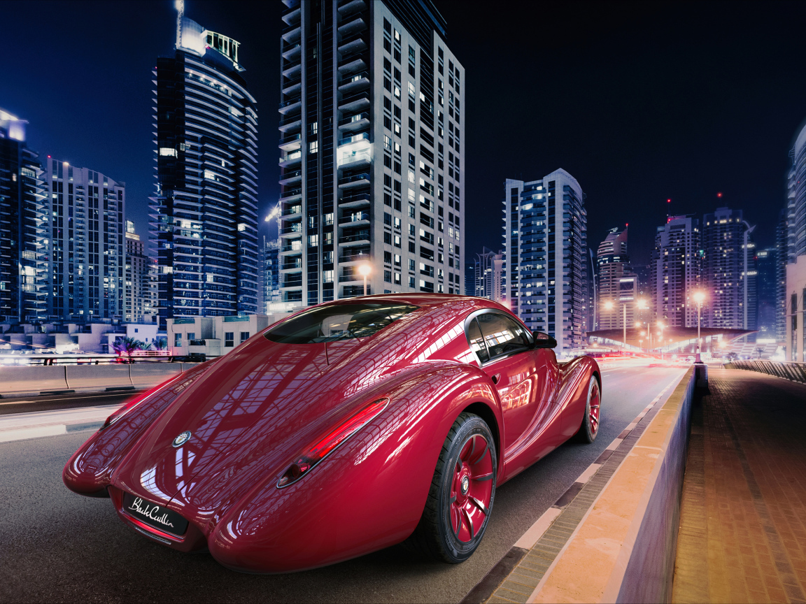 Необычный красный автомобиль Eadon Green Black Cuillin на фоне города 