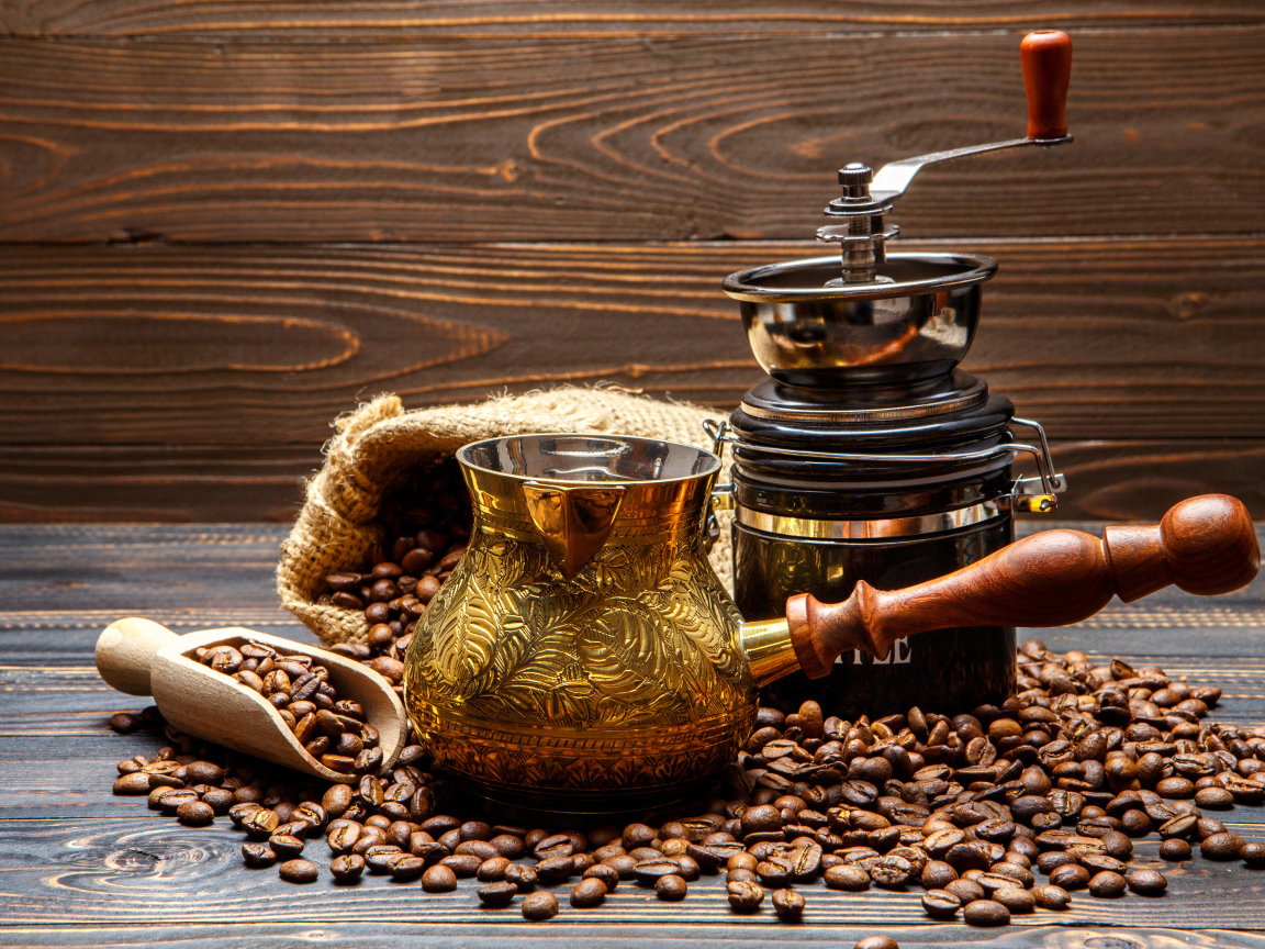 Турка для кофе и кофейные зерна на столе