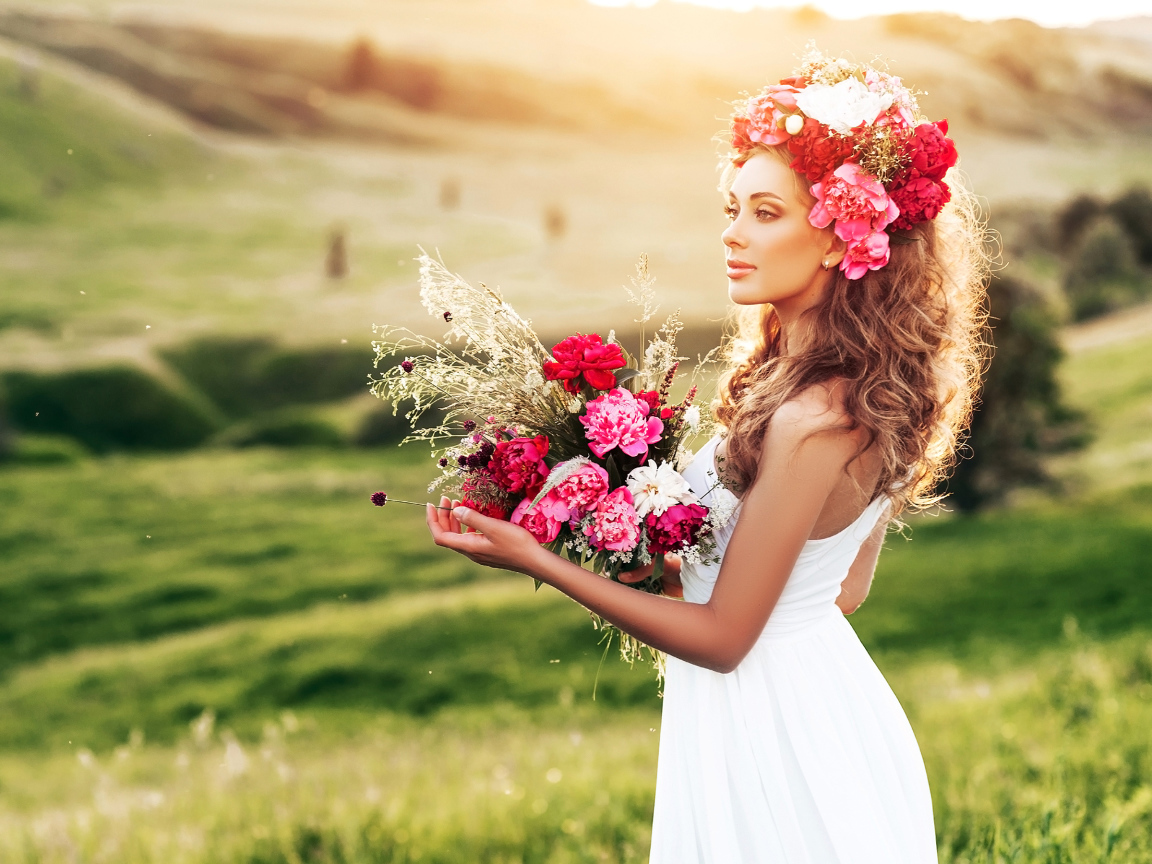 Красивая летняя девушка с букетом цветов и венком на голове