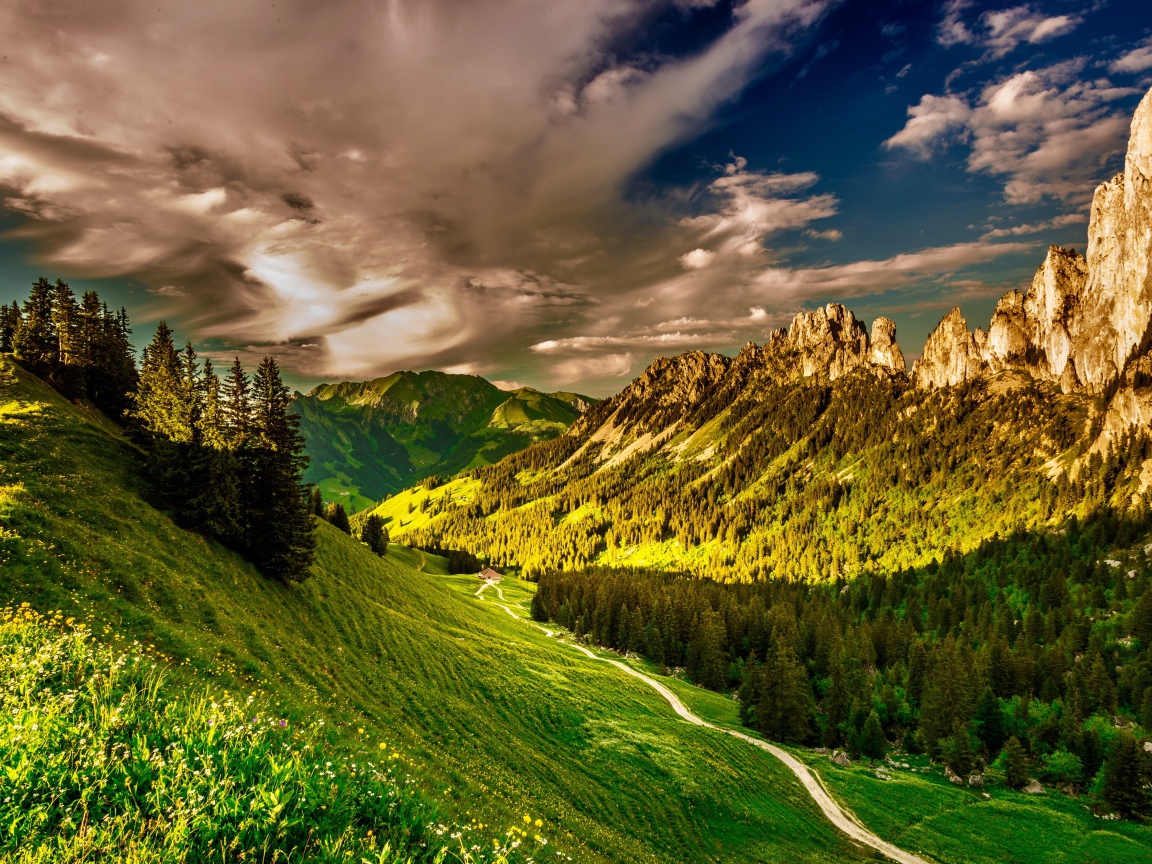 Белые облака над зеленой долиной в лучах солнца