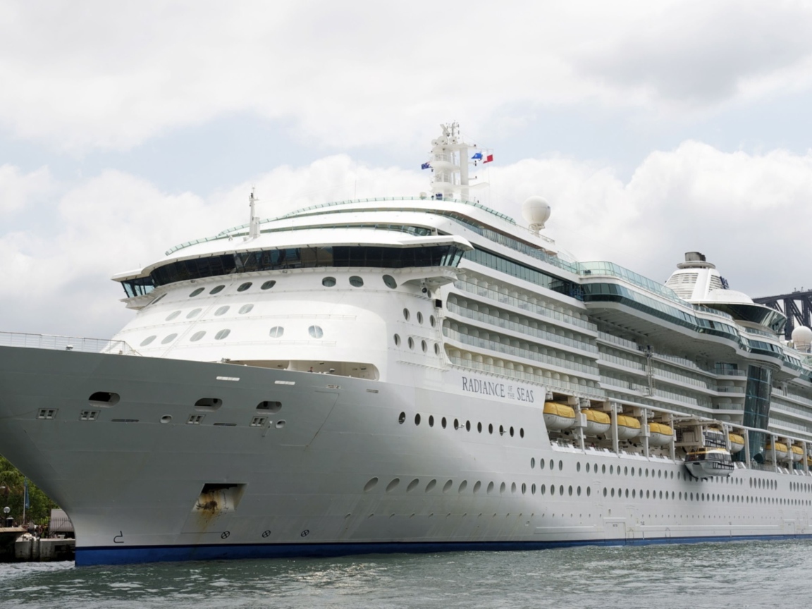 A large white cruise ship Norwegian Breakaway in port