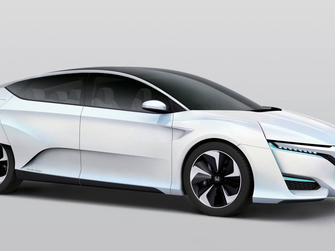 Белый электромобиль  Honda FCv на сером фоне