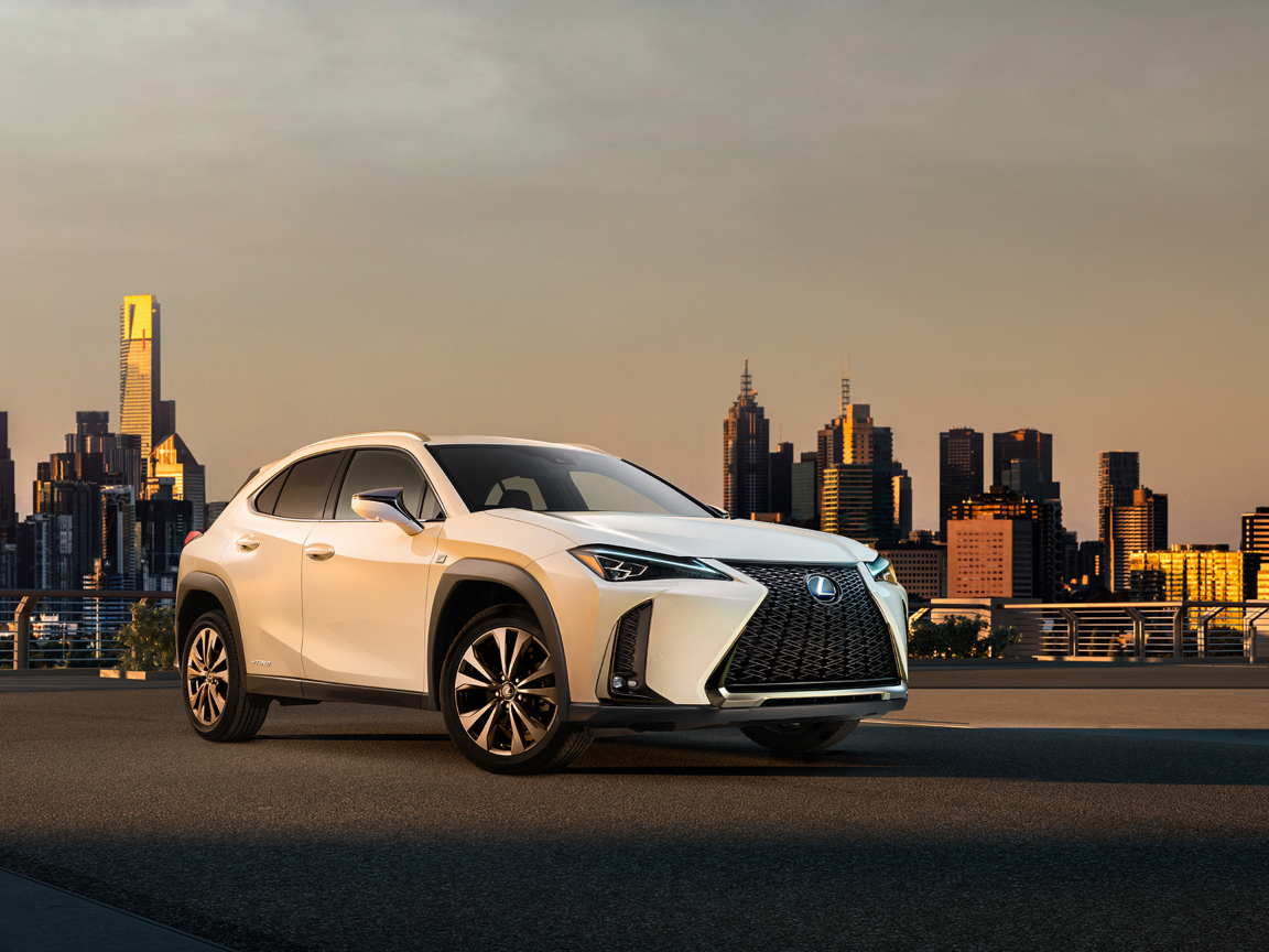 Белый внедорожник Lexus UX, 2019 на фоне города
