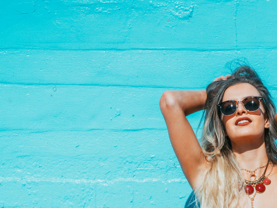 Beautiful girl in sunglasses sunbathing in the summer sun