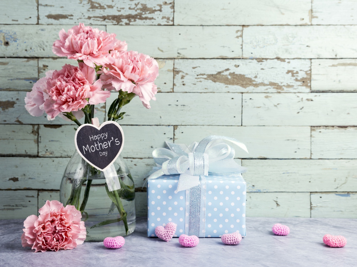 A bouquet of pink carnations and a gift for mother's day