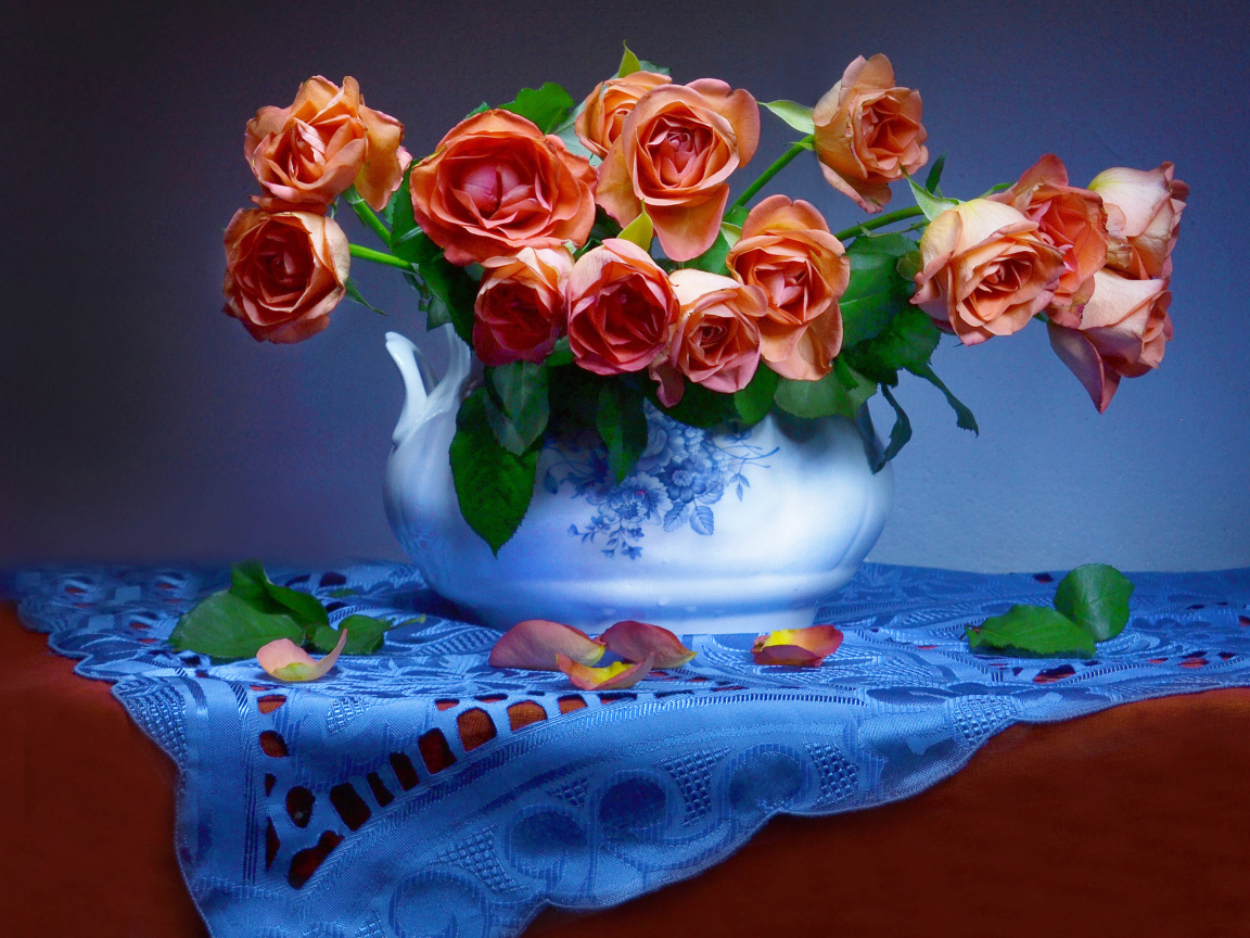 Букет оранжевых роз в вазе на столе 