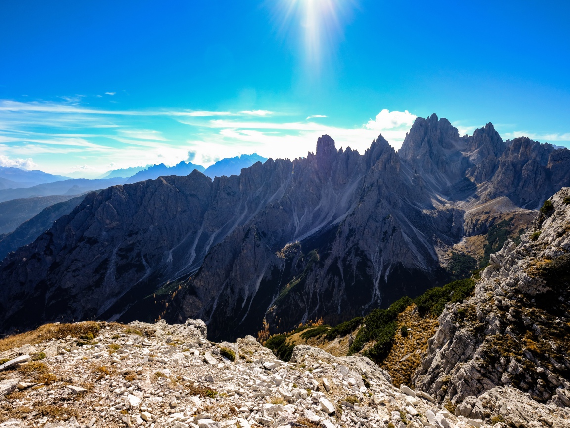 Яркое солнце в голубом небе над горами