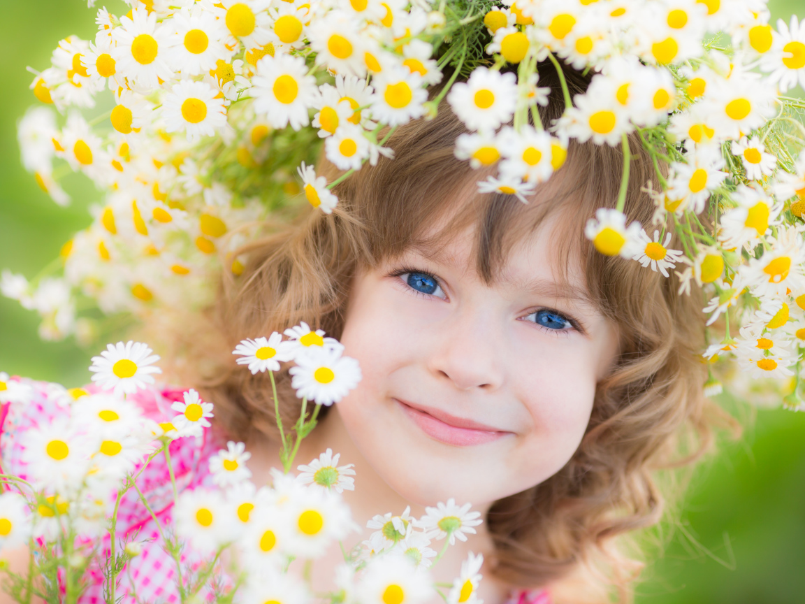 Маленькая девочка с венком из ромашек на голове