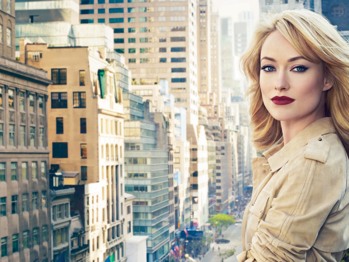 Bright blonde actress Olivia Wilde on the background of the city