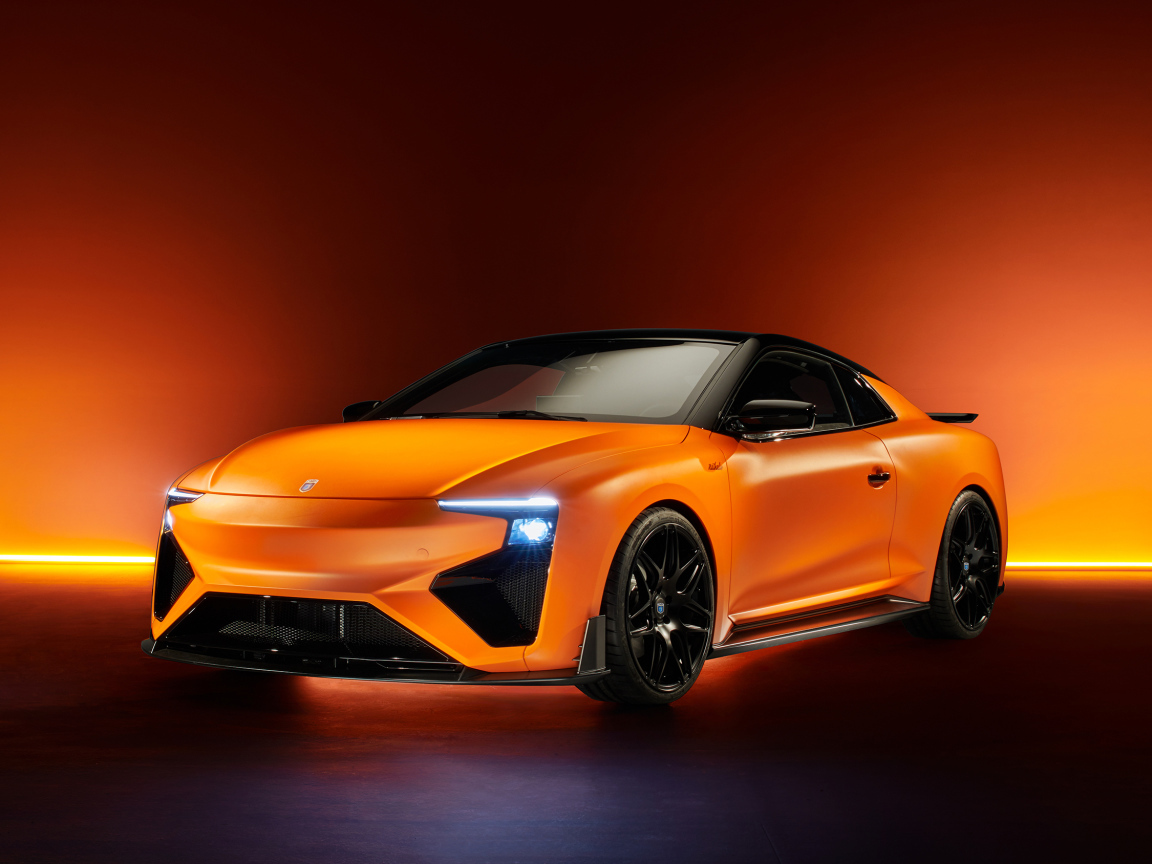Оранжевый автомобиль Gumpert RG Nathalie 2019 года с включенными фарами