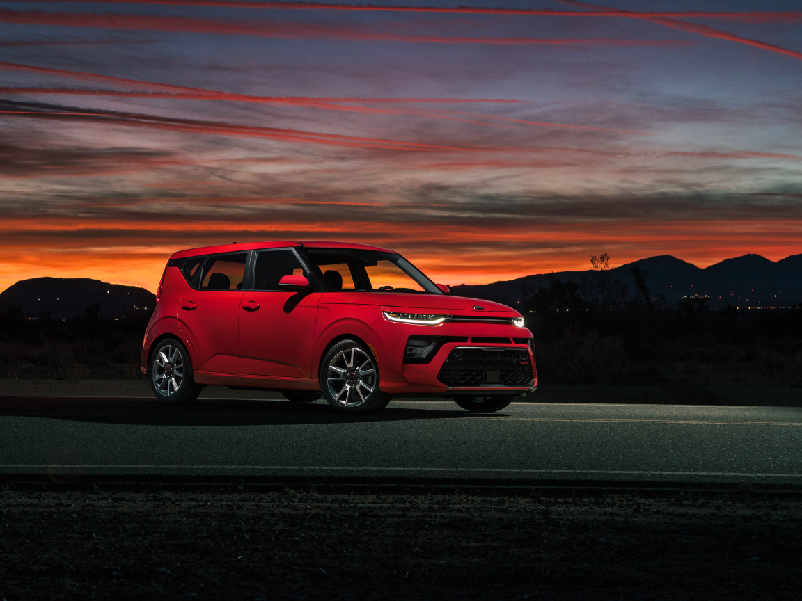Красный автомобиль Kia Soul GT-Line, 2020 года на фоне ночного неба