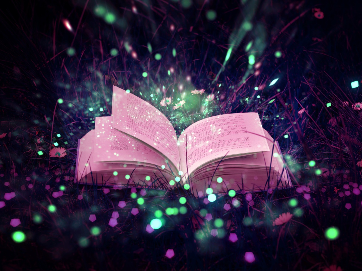 An open magic book lies in the grass