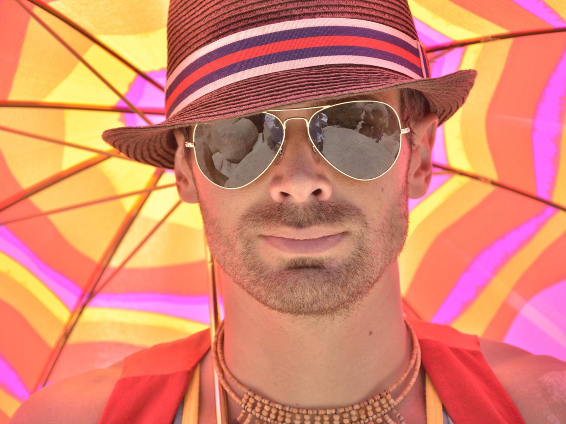 Мужчина в солнечных очках и шляпе летом