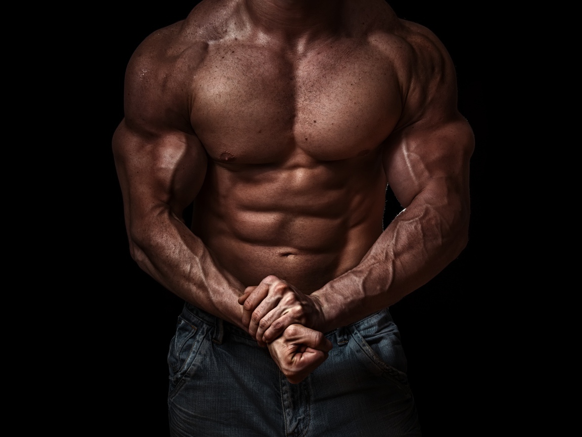 Body of a pumped man on a black background