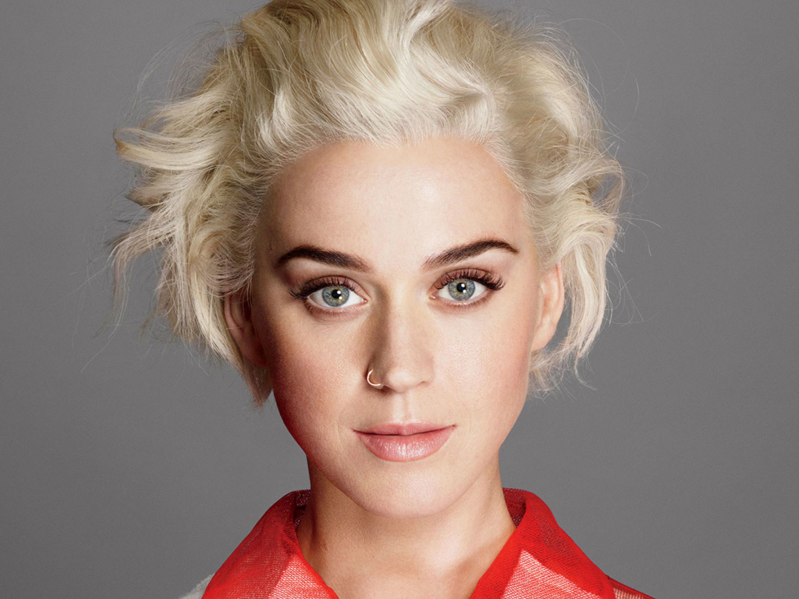 Певица Кэти Перри с короткой стрижкой на сером фоне