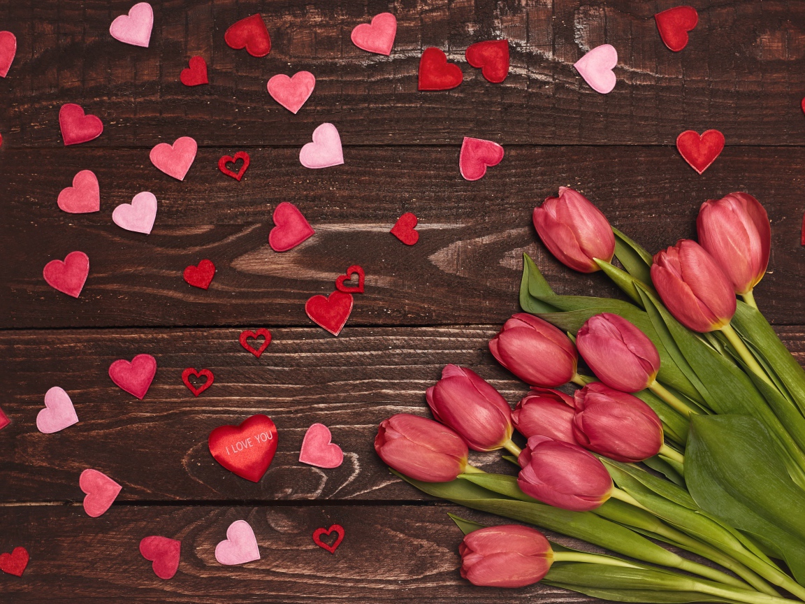 Букет тюльпанов на деревянном фоне с сердечками