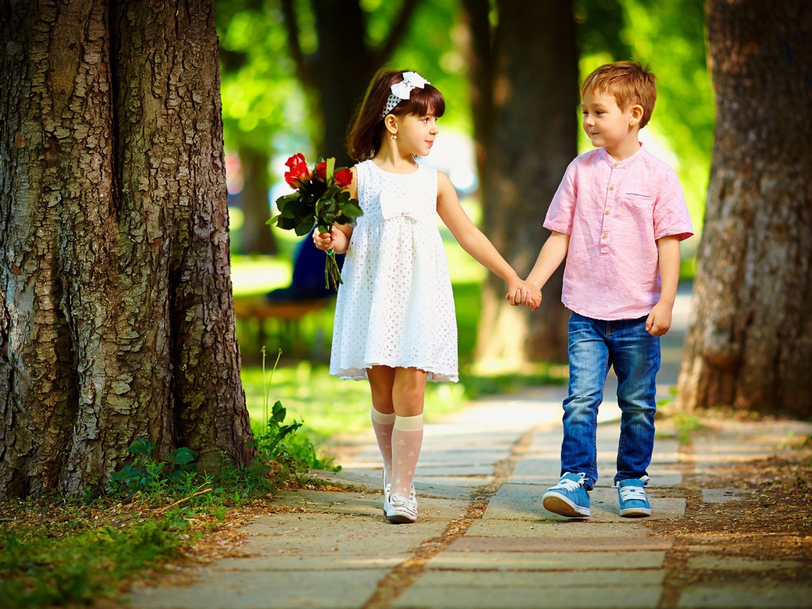 Boy and girl walk in the park