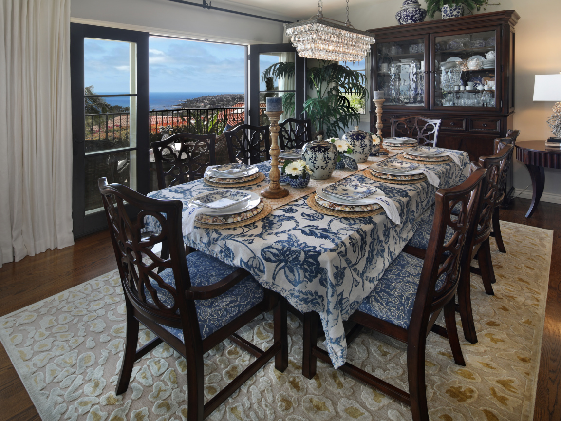 Столовая комната с большим дубовым столом  и красивой посудой