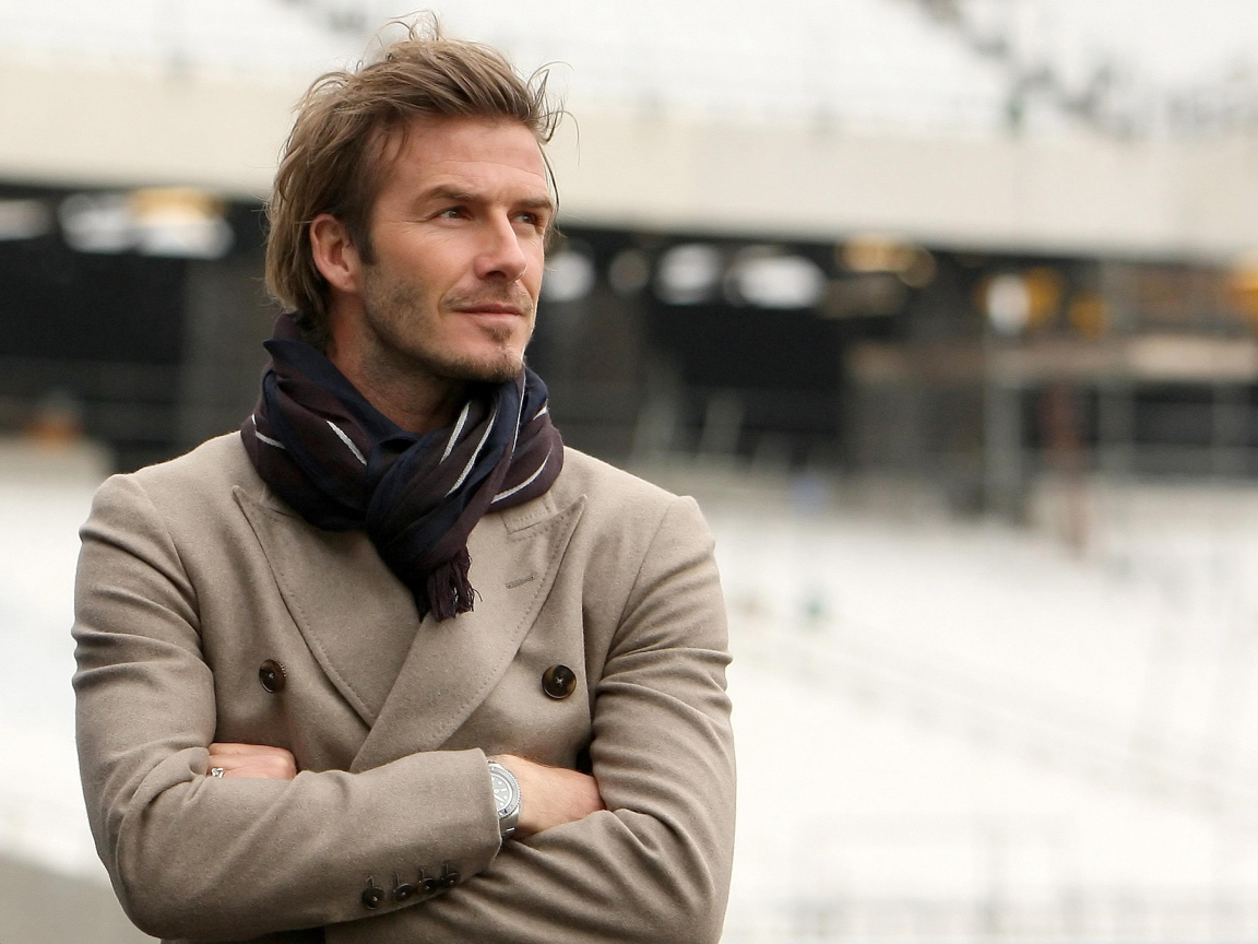 Soccer player David Beckham in a suit with a scarf around his neck