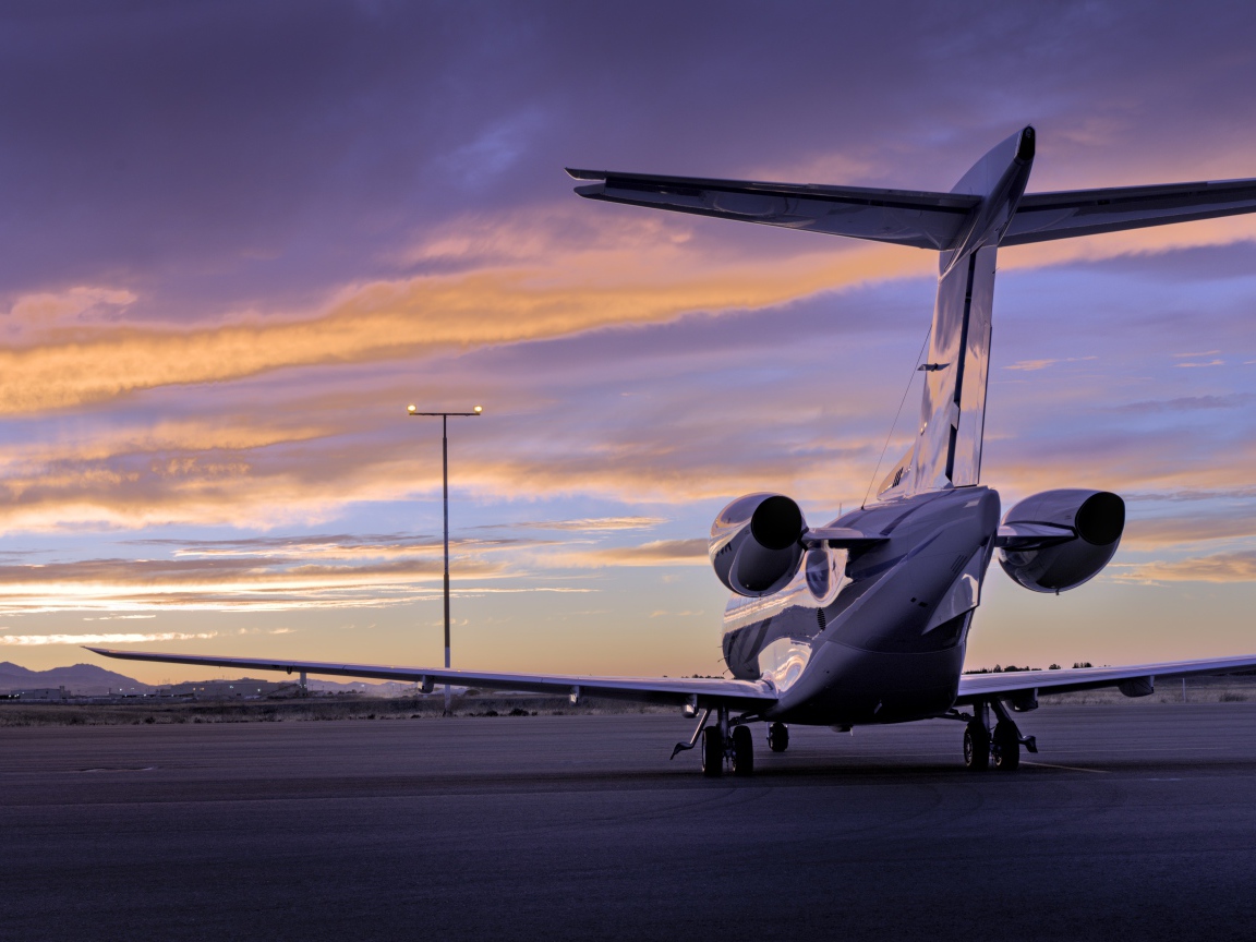 Большой самолет стоит на взлетной полосе  вид сзади