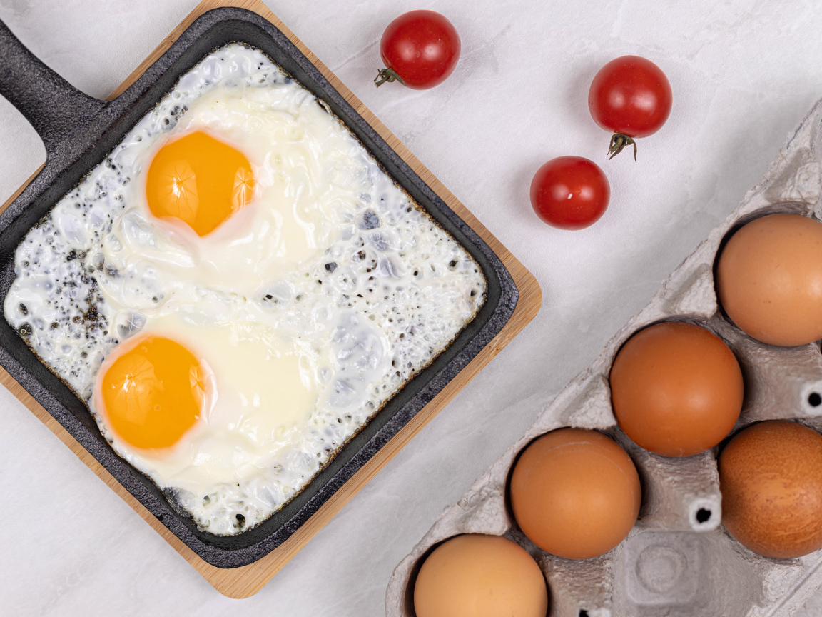 Яичница с помидорами и яйцами на столе