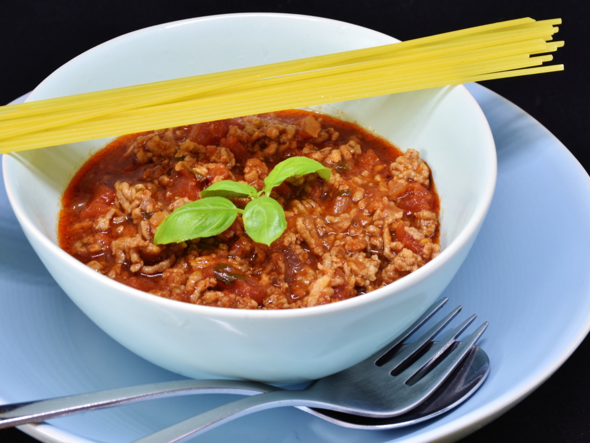 Спагетти с острым соусом с мясом на столе 