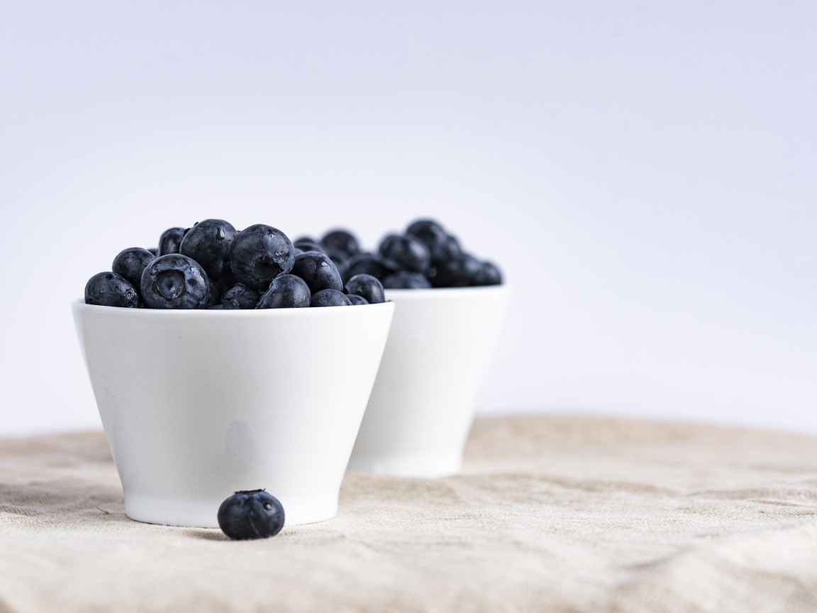 Blue berries blueberries in a white bowl on the table