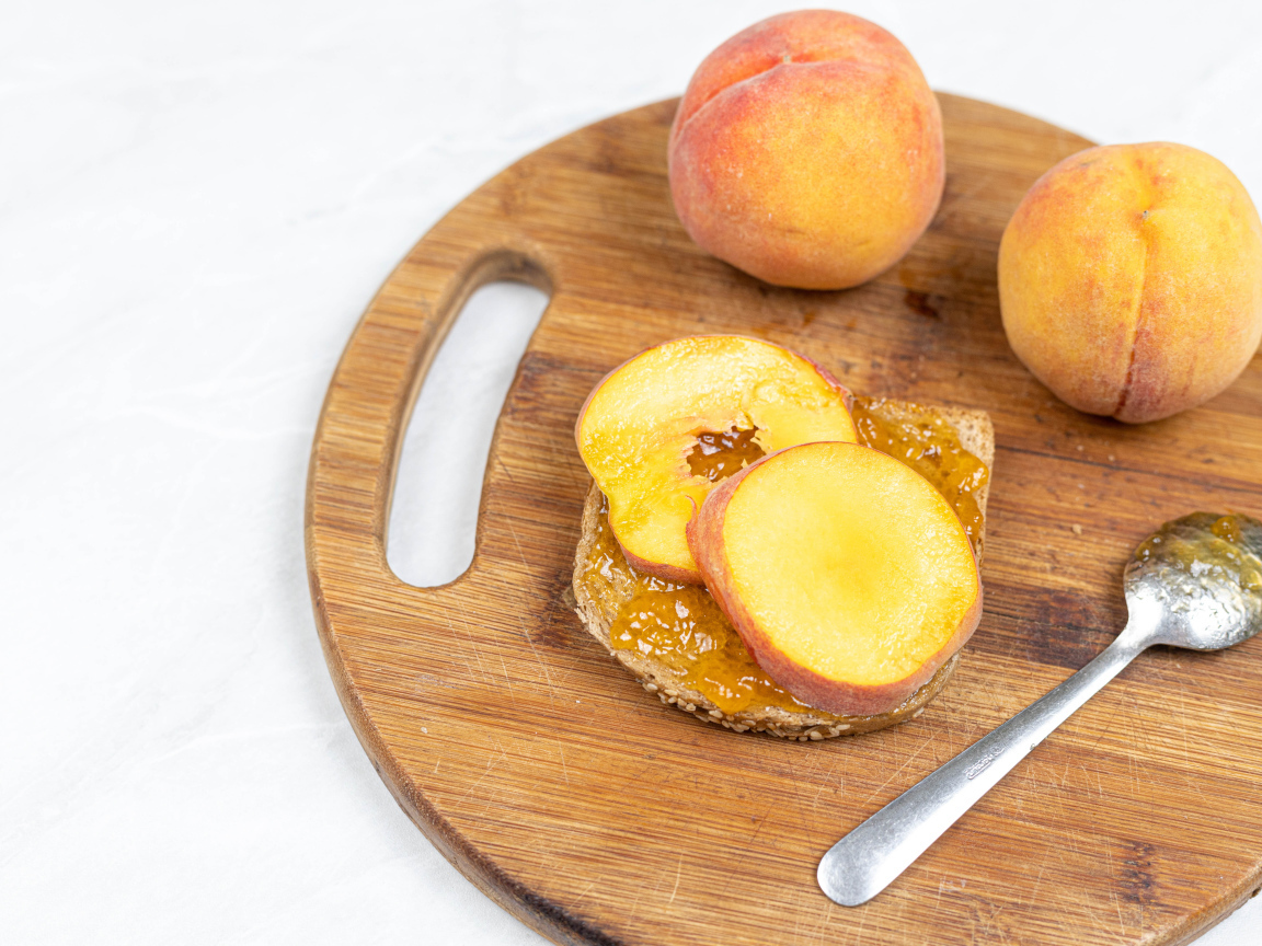 Fresh peaches on the table with bread