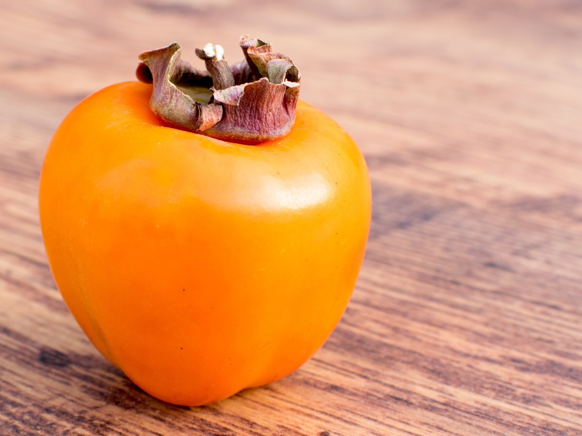 Ripe juicy persimmon on the table
