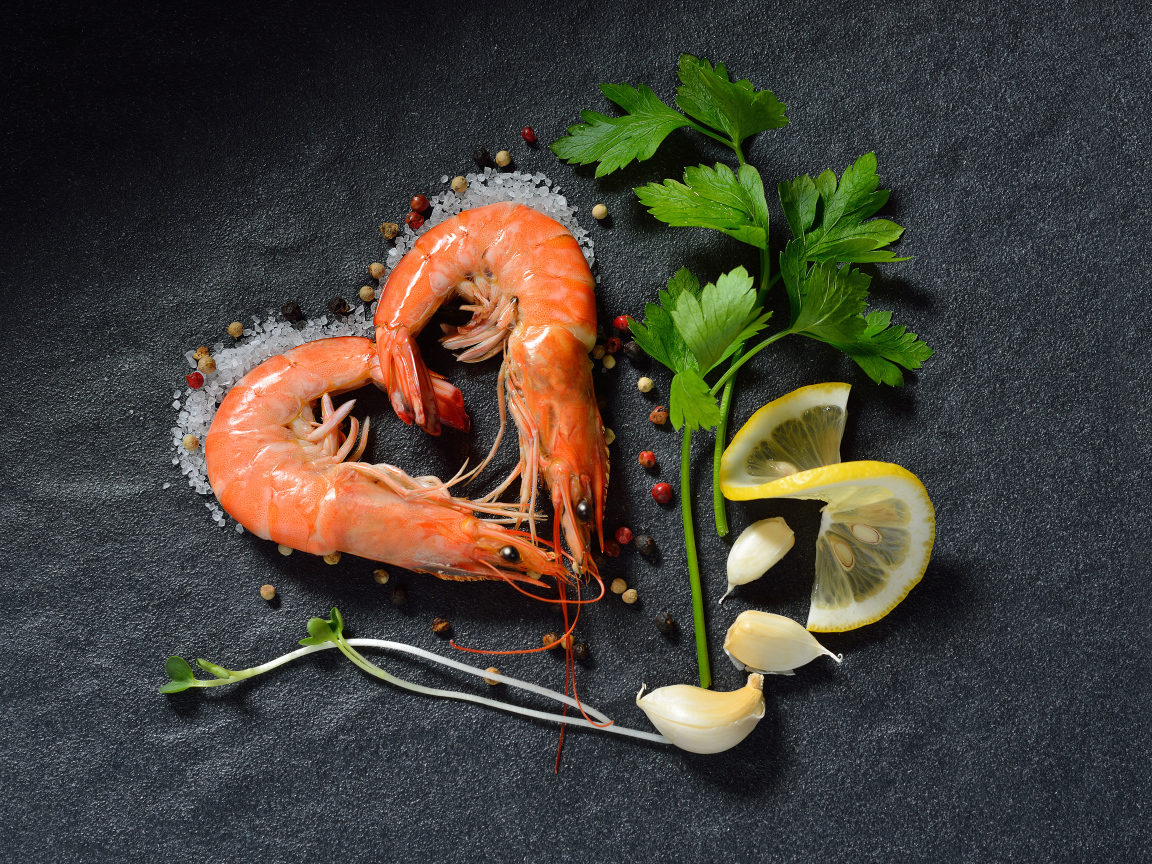 Shrimp heart on a gray table with lemon and a sprig of parsley