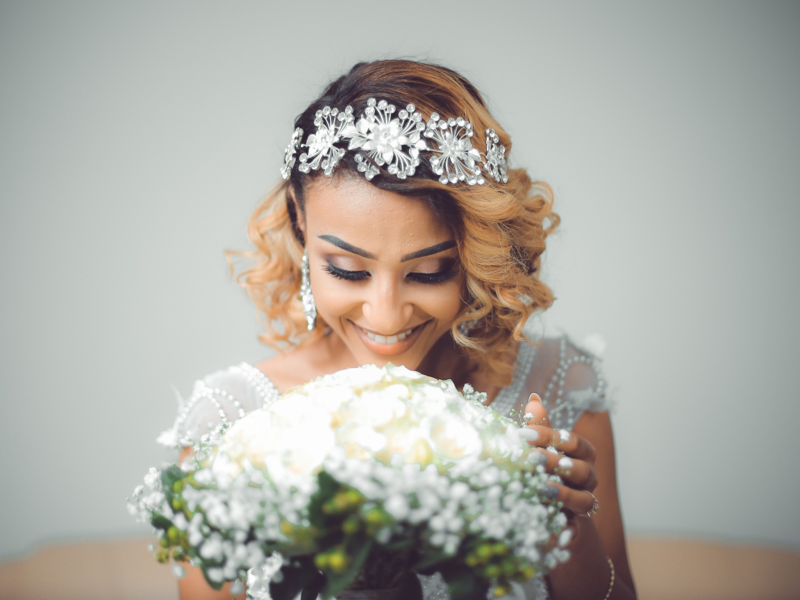 Улыбающаяся девушка невеста с букетом цветов 