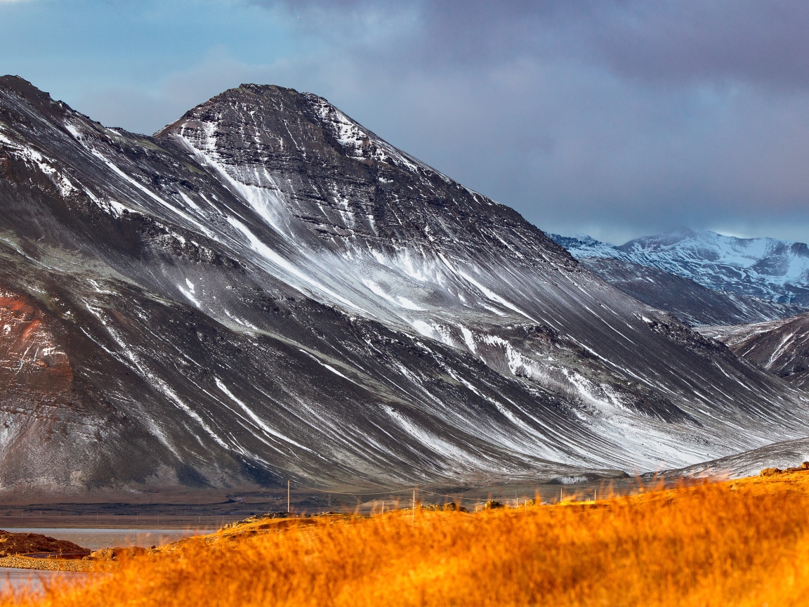 Большие горы с белым снегом под грозовым небом