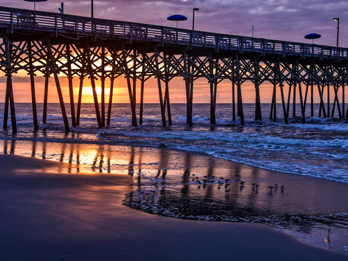 Кафе на мосту у моря на закате 