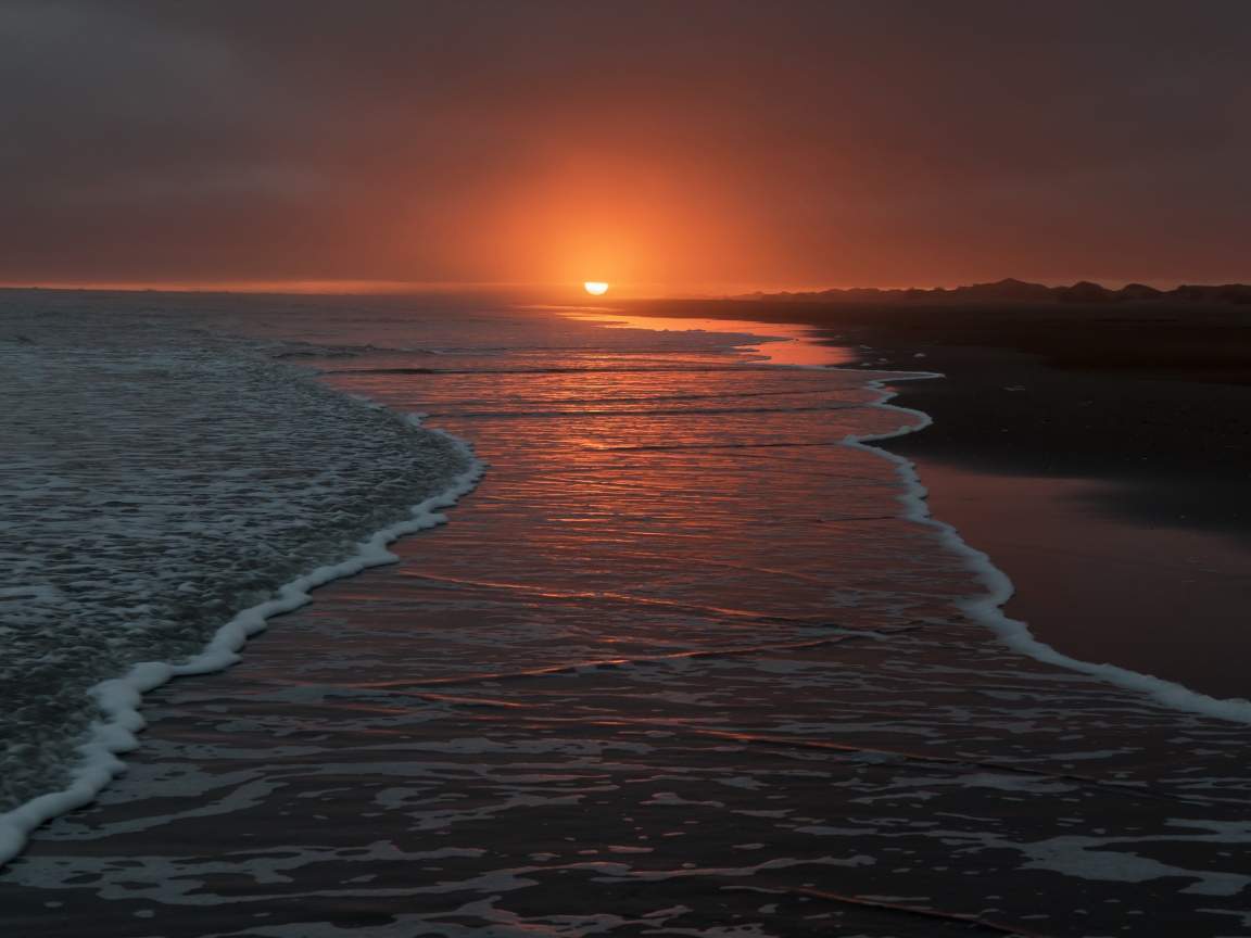 Quiet waves by the sea at sunset