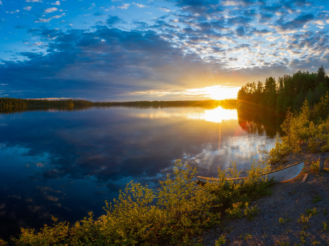 Закат солнца в небе над спокойным озером