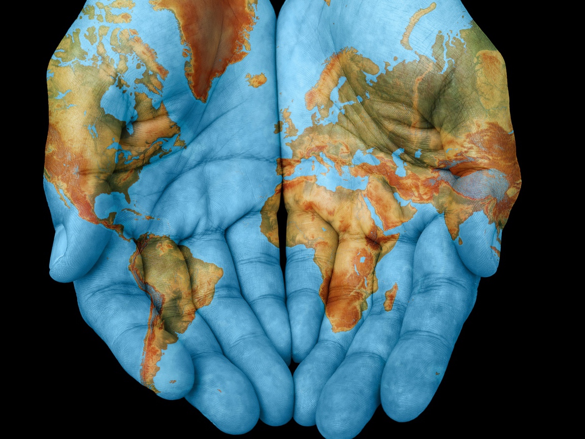 Hands with world map on black background