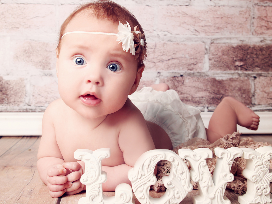 Cute blue-eyed baby with the inscription love