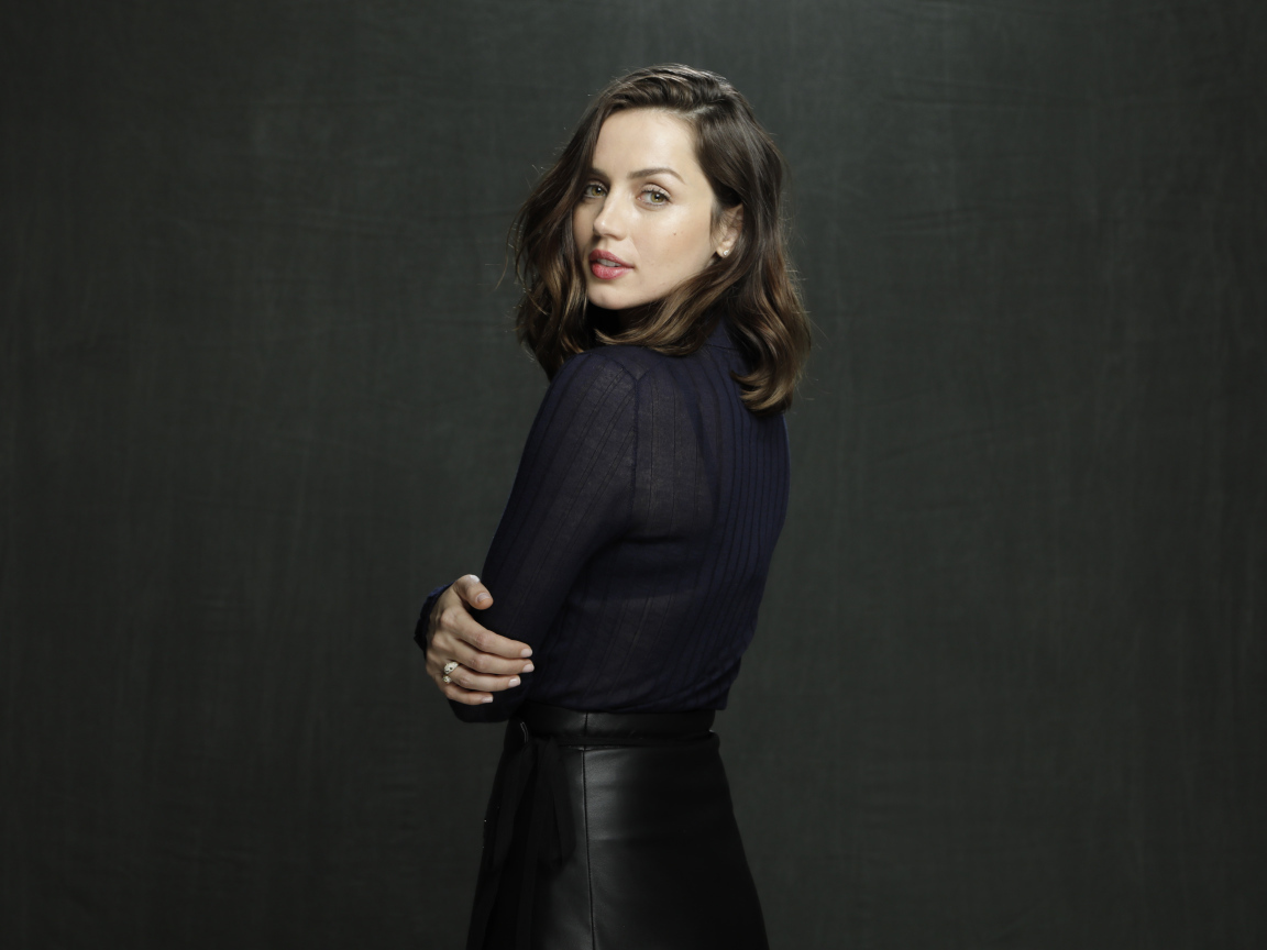 Актриса Ана де Армас в черной юбке на сером фоне