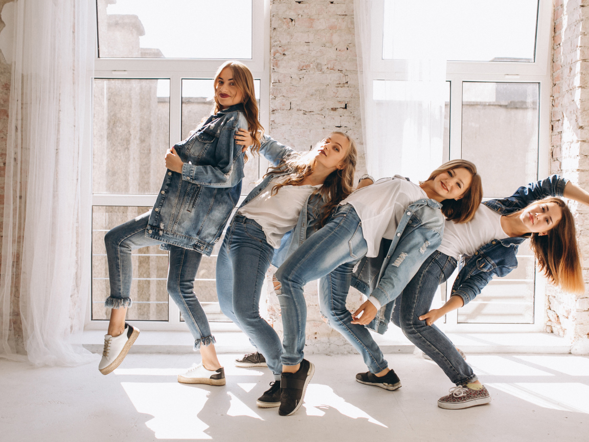 Четыре девушки в джинсовых костюмах занимаются танцами