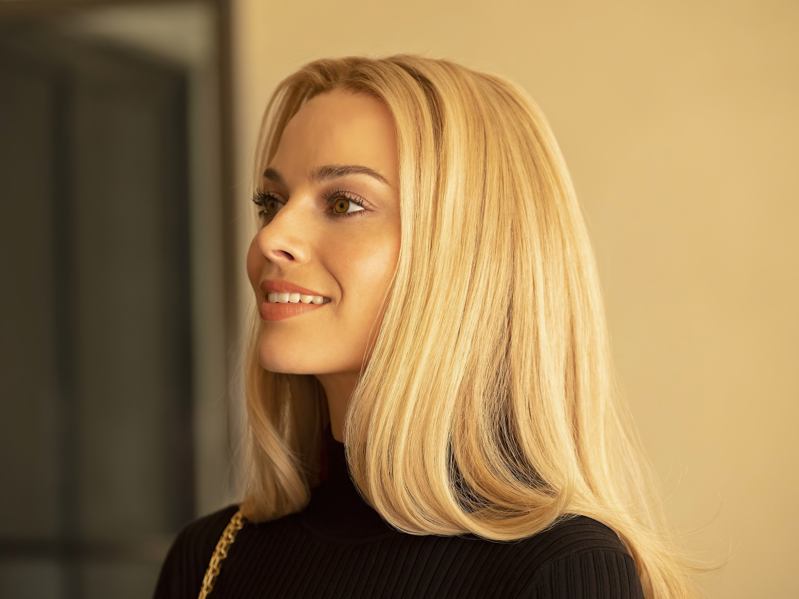 Улыбающаяся блондинка, актриса Марго Робби с карими  глазами