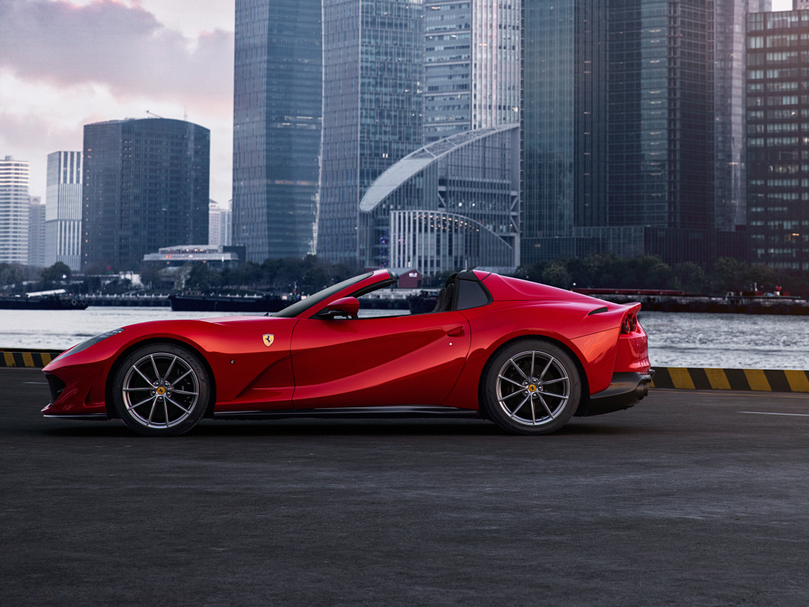Красный автомобиль  Ferrari 812 GTS на фоне города